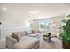 Comfortable living room with large sectional couch, windows, and bright lighting at 26 Kitty Branch Way, Smithfield, NC 27577