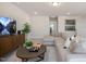 A brightly lit living room with sectional sofa and view through open doorway at 26 Kitty Branch Way, Smithfield, NC 27577