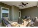 Relaxing covered patio with comfortable seating and a fan at 26 Kitty Branch Way, Smithfield, NC 27577