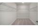 A walk-in closet with white walls, gray carpet, and metal shelving at 26 Kitty Branch Way, Smithfield, NC 27577