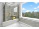 Bright bathroom featuring a separate shower and tub with light wood look tile at 2612 Nordmann Fir Rd, Raleigh, NC 27616