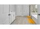 Bright bathroom featuring a shower and tub combination with grey tile at 2612 Nordmann Fir Rd, Raleigh, NC 27616