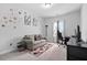 A bedroom area with a gray couch and red circular wall decoration at 2612 Nordmann Fir Rd, Raleigh, NC 27616