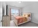 Bedroom with a large window, neutral carpet, and a decorative bedspread at 2612 Nordmann Fir Rd, Raleigh, NC 27616