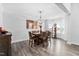 Dining room with modern chandelier, hardwood flooring, bay window, and seating for six guests at 2612 Nordmann Fir Rd, Raleigh, NC 27616
