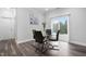 Modern dining room with a glass-top table, sleek chairs, and sliding glass doors to outdoor space at 2612 Nordmann Fir Rd, Raleigh, NC 27616