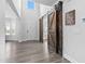 Open foyer with high ceilings, barn doors, and modern flooring creating a welcoming entrance at 2612 Nordmann Fir Rd, Raleigh, NC 27616