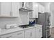 Well-appointed kitchen featuring white cabinets, stainless steel appliances, and a subway tile backsplash at 2612 Nordmann Fir Rd, Raleigh, NC 27616