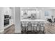 Beautiful kitchen with white cabinetry, modern lighting, a large island, and bar stools, perfect for entertaining at 2612 Nordmann Fir Rd, Raleigh, NC 27616