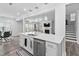 Spacious kitchen island with stainless steel dishwasher, sink, and modern pendant lighting overhead at 2612 Nordmann Fir Rd, Raleigh, NC 27616