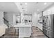 Bright, open kitchen with white cabinets, stainless steel appliances, and a large center island with bar seating at 2612 Nordmann Fir Rd, Raleigh, NC 27616