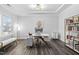 Bright office featuring tray ceiling, luxury vinyl plank floor, modern desk, shelving, and stylish lighting at 2612 Nordmann Fir Rd, Raleigh, NC 27616