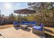 Outdoor patio seating featuring a lounge area with a dark outdoor umbrella on a concrete patio at 2612 Nordmann Fir Rd, Raleigh, NC 27616