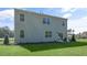 Back of the home featuring a green lawn and patio area for outdoor enjoyment at 273 Hawksmoore Ln, Lillington, NC 27546