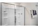 Modern bathroom showcasing a glass-enclosed shower stall with built-in shelves, complemented by towel racks and fixtures at 273 Hawksmoore Ln, Lillington, NC 27546