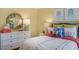 This bedroom is decorated with a rattan mirror and colorful pillows at 273 Hawksmoore Ln, Lillington, NC 27546