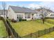 Well-maintained backyard with lawn, patio, and black metal fencing at 2815 Mebane Ln, Durham, NC 27703