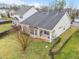 Backyard featuring well-maintained lawn, patio, black metal fencing, and retaining wall at 2815 Mebane Ln, Durham, NC 27703