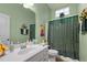 Bathroom featuring a single sink vanity, commode, and shower-tub combination at 2815 Mebane Ln, Durham, NC 27703