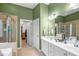 Bathroom featuring double vanity, tiled shower, and bathtub in a serene setting at 2815 Mebane Ln, Durham, NC 27703