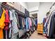 Walk in closet with rows of hanging clothes and shelves for storage at 2815 Mebane Ln, Durham, NC 27703