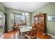 Bright dining room with hardwood floors, large window, and wood china cabinet at 2815 Mebane Ln, Durham, NC 27703