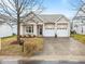 Charming single-story home features a two-car garage, front porch with columns, and well-maintained landscaping at 2815 Mebane Ln, Durham, NC 27703