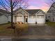 Charming single-story home features a two-car garage, front porch with columns, and well-maintained landscaping at 2815 Mebane Ln, Durham, NC 27703