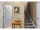 Hallway with a carpeted staircase, artwork, and a side table at 2815 Mebane Ln, Durham, NC 27703