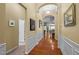 Elegant hallway boasts hardwood floors, wainscoting, and arched doorways at 2815 Mebane Ln, Durham, NC 27703