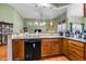 Open concept kitchen with wooden cabinets and hardwood floors showcases open access to living space at 2815 Mebane Ln, Durham, NC 27703