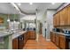 Open kitchen with hardwood floors, wooden cabinets, and a breakfast bar at 2815 Mebane Ln, Durham, NC 27703