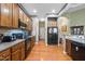 Spacious kitchen features wood cabinets, black appliances, and hardwood floors at 2815 Mebane Ln, Durham, NC 27703