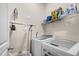Bright laundry room with a washer, dryer, and a shelf for storage at 2815 Mebane Ln, Durham, NC 27703