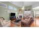 Cozy living room with fireplace, ceiling fan, and comfortable seating area at 2815 Mebane Ln, Durham, NC 27703