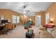 Large living room area with carpet, a ceiling fan, and a desk at 2815 Mebane Ln, Durham, NC 27703