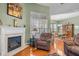 Living room with fireplace and hardwood floors, leading to the dining room at 2815 Mebane Ln, Durham, NC 27703