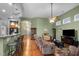 Open-concept living room with hardwood floors, comfortable seating, and a seamless flow to the kitchen area at 2815 Mebane Ln, Durham, NC 27703