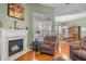 Comfortable living area with a fireplace, hardwood floors, and open view to dining area at 2815 Mebane Ln, Durham, NC 27703
