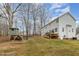 Backyard featuring a home, playground with a swing set, deck, and a large yard with trees at 296 Trenburg Pl, Clayton, NC 27520