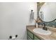 Stylish half bath with floral wallpaper, decorative mirror, and modern fixtures at 296 Trenburg Pl, Clayton, NC 27520