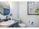 Bright bathroom featuring modern vanity, fixtures and a large window at 296 Trenburg Pl, Clayton, NC 27520