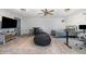 Bedroom with a large area rug, a black bean bag, fan, bed, and a wooden table with bar stool chairs at 296 Trenburg Pl, Clayton, NC 27520