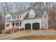 Spacious two-story home with an attached two-car garage and inviting front porch at 296 Trenburg Pl, Clayton, NC 27520