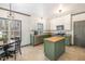 Well-lit kitchen with updated appliances, center island, and adjacent dining area at 296 Trenburg Pl, Clayton, NC 27520