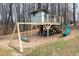 Playground featuring a treehouse, slide, stairs, and a swing set in the backyard surrounded by trees at 296 Trenburg Pl, Clayton, NC 27520