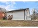 A view of the back of the house with white siding and stairs leading to a back door at 318 Fulton St, Burlington, NC 27217