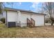 A view of the back of the house with white siding and stairs leading to a back door at 318 Fulton St, Burlington, NC 27217