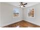 Bedroom featuring hardwood flooring, a ceiling fan, and windows with natural light at 318 Fulton St, Burlington, NC 27217