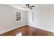 Bedroom featuring hardwood flooring, ceiling fan, built-in shelves, and natural light at 318 Fulton St, Burlington, NC 27217